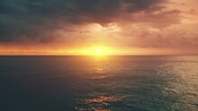 Dramatic Orange Ocean Sunset. Aerial Hyperlapse Flight. Bright Yellow Sun Reflection In Sea Waves And Dark Low Rainy Clouds. Nature Background. Beautiful Wild Travel Landscape. Exotic Summer Vacation.