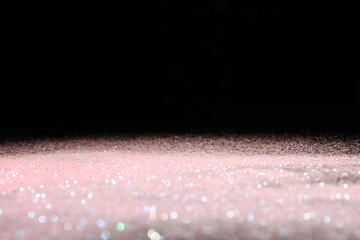 Wall Mural - shiny pink glitter on black background, space for text. bokeh effect