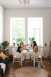 © diignat - Mom, I can share everything with you. Mother and her daughter are sitting in the kitchen having a cup of tea and talking.