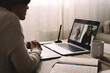 Young woman having video call with her colleagues using computer app - Multi generational business videocall - Focus on screen