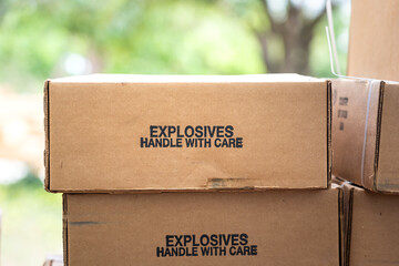 stack of the explosive material carton box which is label as handle with care text on it. weapon and