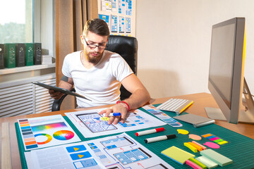 Wall Mural - ux designer at work. he draws app layouts on paper. ux designer career. application development proc