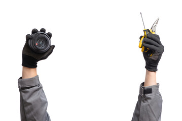 CCTV security camera and work tools in the hands close up isolated on the white background.