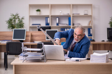 Wall Mural - Old businessman employee after accident working in the office