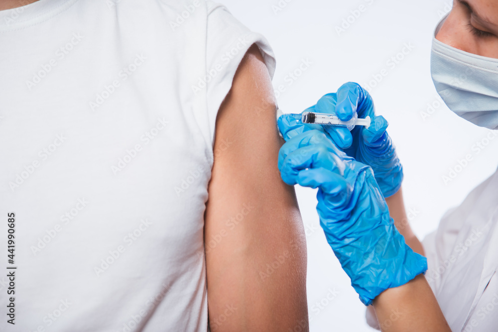 Girl doctor holds a syringe and makes an injection to a patient in a ...