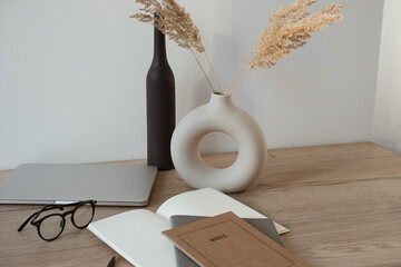 Wall Mural - Home office desk workspace with laptop, notebook, glasses on wooden background. Aesthetic blog, web, social media concept.