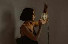 Woman With Glowing Lantern In Room