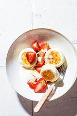 Poster - Homemade cottage cheese fritters - syrniki with strawberry and yogurt. Russian and Ukrainian cuisine concept.