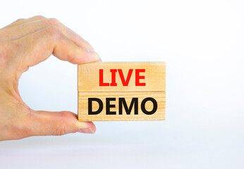 Live demo symbol. Concept words 'live demo' on wooden blocks on a beautiful white background. Businessman hand. Copy space. Business and live demo concept.