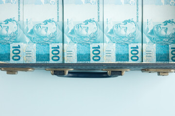 Wall Mural - Brazilian money stacked in a suitcase, Empty space for text, Business and financial concept.