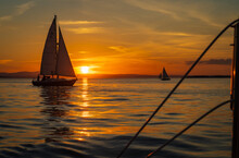 Setting Sun On Lake Champlain Enjoyed By Sail Boats 
