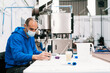 © ADDICTIVE STOCK - Quality assurance engineer analyzing wort in brewery