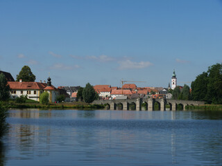 Sticker - Beautifiul view of the river surrounded by houses and fields on a sunny day