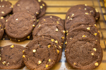 Close up view of chocolate cakes on wooden shelf. 