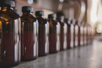 Row of brown medicine bottle without copyspace label design pattern, selective focus