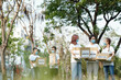 © DragonImages - Group of young volunteers in medical masks gathering in park to collect donations for charitable foundation
