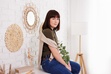 Wall Mural - home and cosiness concept - portrait of attractive woman sitting on shelf at home