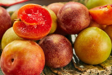 Canvas Print - Red and yellow fresh plums on plate ready to eat