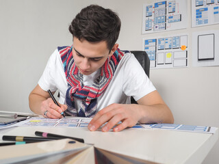 Wall Mural - apps developer at runtime. guy works in apps developer. he draws app layouts on paper. guy surrounde