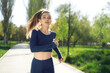 © fotofabrika - Athletic fit young woman jogging early in the morning in park