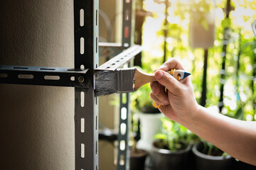 do it yourself concept, Craftsmen use anti-rust paint to paint old iron parts. Make a shelf on your free weekend