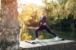 © fotofabrika - Fit young woman exercising on mat in the park