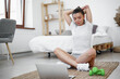 © fotofabrika - Young woman in sportswear using laptop to watch workout video tutorials at home