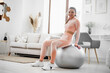 © fotofabrika - Sporty woman doing abs exercises on fitness ball at home