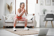 © fotofabrika - Young fitness girl doing sport exercises at her living room at home