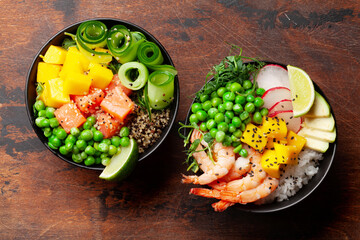 Wall Mural - Poke bowls with shrimps, salmon, avocado and mango