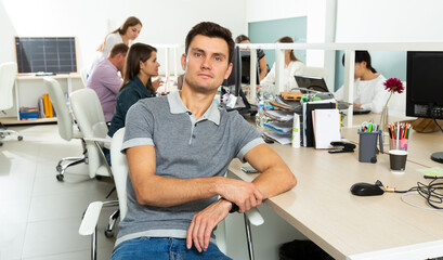 Wall Mural - Portrait of male manager sitting at his workplace in office