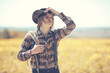 © alexkich - Cowboy with hat in a field in autumn