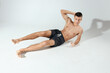 © SHOTPRIME STUDIO - man doing exercises lying on the floor indoors morning exercises