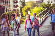 © liderina - School kids walking in schoolyard.
