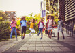 © liderina - Group of elementary age schoolchildren jumping in schoolyard.