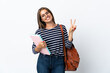 © luismolinero - Young student woman isolated on white background showing victory sign with both hands