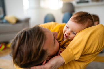 Poster - Happy young father playing with little daughter at home