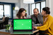 © DC Studio - Businesspeople analysing annual financial reports sitting at desk in back of laptop with green screen chroma key display, mock up desktop. Leader explainig project strategy using greenscreen pc