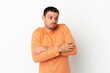 © luismolinero - Brazilian man over isolated white background making doubts gesture while lifting the shoulders