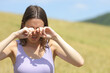 © PheelingsMedia - Allergic woman scratching eyes in a wheat field