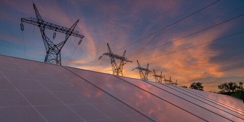 Wall Mural - photovoltaic panels and high voltage pylons against the background of the evening sky