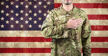 Composition of midsection of male soldier with hand on heart, against american flag