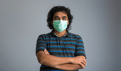 Closeup portrait of a young man wearing a medical or surgical mask