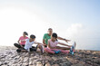 asian parent and children do sport outdoor. healthy family stretching and exercise in the morning