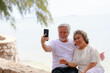 © sutthichai - Happy Asian senior couple enjoy playing smartphone outdoor. Retirement and love concept.