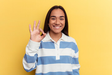 Wall Mural - Young mixed race woman isolated on yellow background cheerful and confident showing ok gesture.