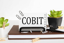COBIT - Text On White Paper On White Background