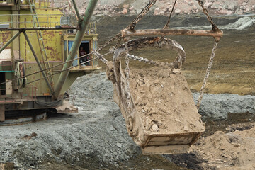 Wall Mural - large excavator loads rock with iron or bauxite mining