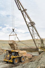 Wall Mural - large excavator loads rock with iron or bauxite mining