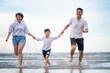 © Me studio - a happy family having fun on a beach